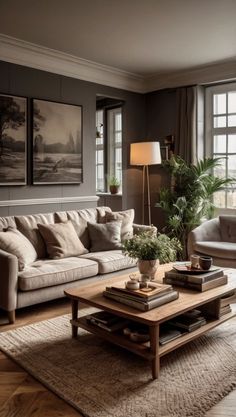 a living room with two couches and a coffee table in front of large windows