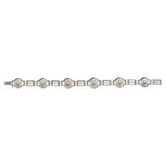 An Art Deco natural pearl, diamond and platinum bracelet, of an alternating circle and rectangle design, with six, graduating, two row platinum rings, each with clusters, set with natural, bouton pearls, on gold backed settings, in the centre of twelve, old-cut diamonds, with millegrain edged settings, the two row edged rectangles are set with three old-cut diamonds, in millegrain edged rub over settings, joined by double, granulated links, mounted in platinum, with a safety chain and box and to Antique Diamond Earrings, White Gold Cross Pendant, Platinum Rings, Art Deco Pendant Necklace, Diamond Cufflink, Rectangle Design, Platinum Bracelet, Platinum Earrings, Art Deco Bracelet