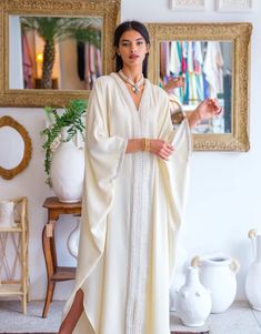 Elevate your wardrobe with our " Embellished Crepe Kaftan ," a stunning crepe kaftan that embodies the essence of Moroccan elegance and craftsmanship.   Product Details:     Crafted from Premium Crepe: This kaftan is made from 100% crepe, ensuring a lightweight and comfortable feel against your skin.    Signature Moroccan Embellishments: Adorned with intricate golden "sfifa" and delicate pearls, this kaftan is a masterpiece of Moroccan design. The embellishments add a touch of opulence and tradi Moroccan Outfit, Silk Abaya, Morrocan Fashion, Moroccan Clothing, Kaftan Designs, Muslim Style, Moroccan Fashion, Muslim Women Fashion, Mode Abaya