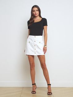 Just in: a versatile four-season miniskirt. The all-cotton denim Kris hugs the natural waist before falling straight to high thigh. Featuring a button-front with welt accents that lend a smart sophistication, and our signature embossed dome buttons. For warm days wear with a tee and sandals or sneakers. Slip on tall boots and a turtleneck when the weather turns cool and crisp. Four Season, Denim Mini, Denim Mini Skirt, Tall Boots, Summer 2024, Mini Skirt, Mini Skirts, Turtle Neck, Slip On