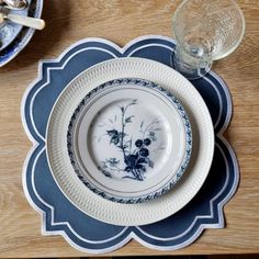 an empty plate on top of a wooden table