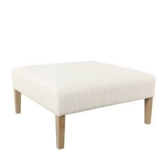 a white foot stool with wooden legs