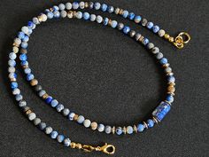 Handmade necklace. Made of small  Lapis lazuli beads and brass beads. Necklace is fastened with lobster clasp.  Approx length   -  46 cm / 18.11 inch. Handmade Blue Lapis Lazuli Necklace, Blue Lapis Lazuli Single Strand Beads, Blue Single Strand Lapis Lazuli Beads, Single Strand Blue Lapis Lazuli Beads, Adjustable Blue Spiritual Necklaces, Blue Beaded Necklaces With Lobster Clasp And Round Beads, Blue Beaded Necklaces With Lobster Clasp, Blue Beads With Lobster Clasp For Jewelry Making, Blue Round Bead Necklace With Lobster Clasp