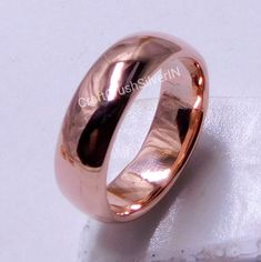 a close up of a wedding ring on a white surface