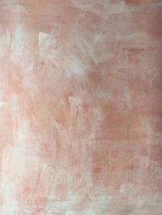 an abstract painting with pink and white paint on the wall, in shades of peach