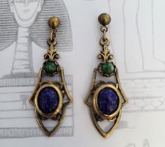 "Only $4 SHIPPING and additional items ship FREE (except doll furniture). Vintage Blue GLASS SCARAB Dangling Earrings made with vintage scarabs and setting.  NOS New Old Stock - vintage but unused jewelry parts. Condition:  Handmade using NOS vintage materials -- \"New Old Stock\".  Not reproductions. NOS materials are old inventory from costume jewelry companies in the 50's that have gone out of business.  These were never sold at retail so they are \"new\" (meaning unused) but \"old\" because of their age.   Size: see last picture" Vintage Blue Brass Earrings, Vintage Handmade Brass Clip-on Earrings, Handmade Vintage Brass Clip-on Earrings, Vintage Cabochon Metal Earrings, Vintage Metal Cabochon Earrings, Harrisburg Pa, Furniture Vintage, Going Out Of Business, Dangling Earrings