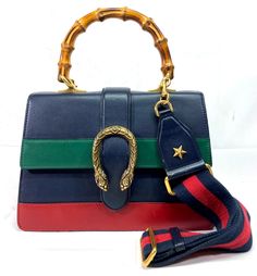 >>FOR SALE<< >>PRE-OWNED<<   Gucci 448075 Dionysus Bamboo Top Handle Colorblock Leather Black/Green/Red Shoulder Bag Bag Sizes - Long - 10.5" Dept - 3" Height - 7.5" Strap Size - 20" + Adjustable Condition - Overall Bag is in a Good Cosmetic Condition! Has Some Sign of Normal Use! Bag Has Few Light but Visible Spots. Strap is in a Great Condition. Strap Has Some Stains on Leather. Interior Has Multiple Stains from Normal Use! Interior is in Acceptable Used Condition! Please Refer to Photos for More Info! ATTENTION: PRE-OWNED WITHOUT TAGS Comes Without Original Box Comes Without Original Dust Bag COMES AS PICTURED PLEASE REVIEW PICTURES FOR CLOSER DETAILS AWESOME DESIGN THIS MODEL WON'T LAST LONG!!! Condition Description: This item is pre-owned. Please refer to pictures for a better underst Green Gucci Bag With Detachable Handle, Gucci Bag With Adjustable Strap For Shopping, Gucci Shoulder Bag With Adjustable Strap For Shopping, Gucci Green Satchel Bag, Gucci Designer Satchel With Detachable Strap, Designer Gucci Satchel With Detachable Strap, Gucci Multicolor Shoulder Bag For Daily Use, Gucci Green Crossbody Bag, Gucci Green Shoulder Bag For Daily Use