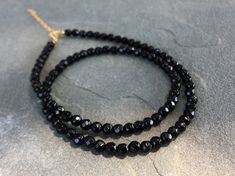 Black Onyx Beaded Necklace, Black Onyx Choker Necklace DETAILS - 4mm Black Onyx Beads - 14K Gold Filled Spring Ring Clasp 5mm - 14K Gold Filled 2 inches Extender Chain - Necklace Length 14 - 16 inches Please note: Because we use natural stones, the stones may vary slightly in shape, shade and size. They may also contain natural inclusions. If you have any questions, please feel free to contact me. This natural black onyx necklace is made with small faceted sparkling black gemstone beads to creat Black Crystal Necklaces With Round Gemstone Beads, Black Onyx Round Bead Crystal Necklaces, Black Onyx Round Beads Crystal Necklace, Black Onyx Round Beads Necklace, Black Onyx Beaded Necklace With Faceted Beads, Black Single Strand Beads For Jewelry Making, Black Faceted Round Beaded Necklaces, Black Faceted Beaded Necklaces, Black Rondelle Beaded Necklaces