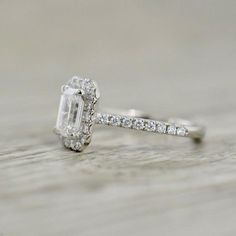 a diamond ring on top of a wooden table