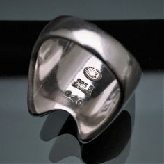 This is a very nice Mid Century Modernist ring by Georg Jensen, Denmark. The ring is style #140 and was designed by Henning Koppel and produced in the 1970's. The ring is marked inside the band with the Jensen mark, Danish Sterling purity stamp, and style number. The ring is in very good vintage condition with only light age related wear. Please be sure to view all of the photos for a complete view of the ring's condition. The ring is a US size 5.5 and weighs .66 Troy ounces. If you have any que Modernist Polished Finish Ring For Anniversary, Modernist Ring With Polished Finish For Anniversary, Modernist Rings With Polished Finish For Anniversary, Modernist Signet Ring With Polished Finish, Modernist Open Ring With Polished Finish, Modern White Gold Collectible Rings, Modernist Wide Band Rings For Anniversary, Modernist Wide Band Ring For Formal Occasions, Modern Engraved Hallmarked Open Ring