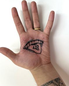 a person's hand with a tattoo on it