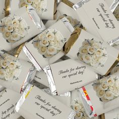 white roses are wrapped in foil and placed on top of each other with thank cards