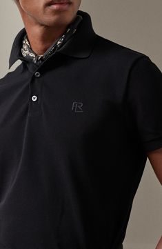 Mercerized for enhanced durability and color retention, this cotton-piqué polo is refined with mother-of-pearl buttons and an embroidered logo. 28 1/2" length (size medium) Button half-placket Spread collar Short sleeves 100% cotton Machine wash, dry flat Made in Italy Designer Clothing Designer Black Polo Shirt With Collared Neckline, Black Designer Polo Shirt With Collared Neckline, Designer Top With Embroidered Logo And Collared Neckline, Designer Tops With Embroidered Logo, Fitted Polo Shirt With Embroidered Logo, Designer Black Polo Shirt With Embroidered Logo, Luxury Short Sleeve Polo Shirt For Work, Collared Polo Shirt With Embroidered Logo For Work, Collared Polo Shirt With Embroidered Logo