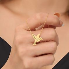 Discover the elegance of our Gold Plated Silver Hummingbird Necklace, a stunning piece of jewelry that captures the beauty of nature. Perfect for any occasion, this necklace is a wonderful gift for bird lovers and those who appreciate fine craftsmanship. Dainty and Stylish. 🌸 Handcrafted Design: Each necklace is meticulously handcrafted, ensuring a unique and high-quality piece. ✨ Premium Materials: Made from sterling silver and plated with gold for a luxurious finish that complements any outfi Elegant Bird Design Jewelry For Gift, Elegant Bird Design Jewelry Gift, Elegant Bird Design Jewelry For Anniversary, Bird Design Pendant Necklace As A Gift, Silver Bird Shaped Jewelry For Gifts, Bird Design Pendant Necklace Gift, Bird Pendant Necklace For Gift, Unique Bird Design Pendant Jewelry, Silver Bird-shaped Jewelry As Gift