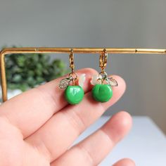 Our green apple huggie earrings are made with glass green apples, acrylic leaves, acrylic flowers and 14K gold plated huggie hoops which are good for delicate ears. Size: approx. 0.5" wide and 1.25" long Trendy Green Hypoallergenic Earrings, Trendy Hypoallergenic Green Earrings, Green Hoop Earrings As A Gift, Cute Adjustable Green Earrings, Trendy Green Dangle Hoop Earrings, Trendy Green Dangle Flower Earrings, Trendy Green Huggie Jewelry, Trendy Green Huggie Hoop Earrings, Hypoallergenic Small Green Huggie Earrings