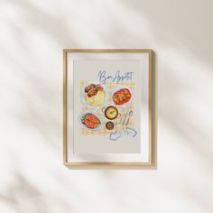 a painting hanging on the wall next to a wooden frame with an illustration of different types of food