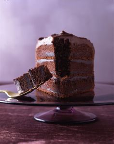 a piece of chocolate cake on a glass plate