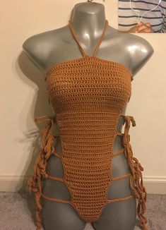 a mannequin wearing a crocheted halter top