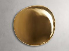 a gold plate on a gray wall