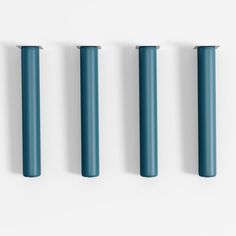 four blue poles are lined up against a white wall and one is in the shape of a rectangle