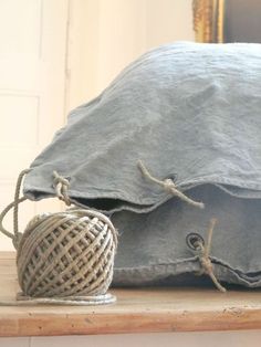 a ball of twine tied to a pillow on top of a table