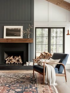 a living room filled with furniture and a fire place in front of a large window