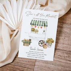 a white card with sunflowers and flowers on it sitting next to a fan