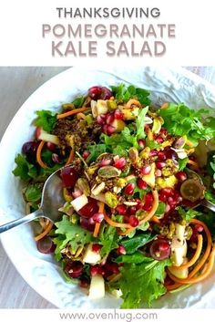 a white bowl filled with salad and topped with pomegranate