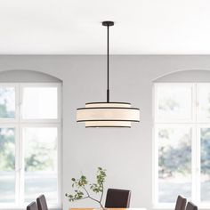 a dining room table with four chairs and a chandelier hanging from the ceiling