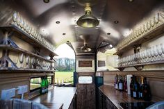 the inside of a bus with lots of wine bottles and glasses