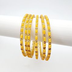 Add a touch of elegance to your ensemble with Priya Glass Bangles. The pale orange/yellow and muted gold colors exude a subtle sophistication. Handcrafted with precision and quality, these bangles are a must-have addition to your jewelry collection. *Sold as a six-piece set.*To prevent any potential damage, please put on each glass bangle individually. For a snug fit, we suggest sizing up from your usual bangle size. Adjustable Yellow Round Bangle, Elegant Yellow Jewelry For Festive Occasions, Elegant Yellow Jewelry For Festivities, Elegant Yellow Festive Jewelry, Orange Bangle For Festivals, Orange Festival Bangle Jewelry, Elegant Adjustable Yellow Bangle, Elegant Orange Bangle Bracelet, Festive Yellow Round Jewelry