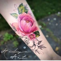 a woman's leg with a pink flower tattoo on her left arm and the words, garden art written in cursive writing