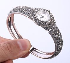 WATCH SIMULATED MARCASITE .925 SOLID STERLING SILVER BANGLE BRACELET #28063 Material is .925 Solid Sterling Silver. The stones are . This Bangle Bracelet is 46,82 grams. Width is 1,03". Inner diamater is 2.90". All our silver items have the 925 stamp. ***All our items are made in EUROPE with high quality workmanship*** Visit our other auctions for great deals PLEASE READ: Your satisfaction is our priority. 100% Satisfaction Guarantee. Returns are accepted within 14 days after item delivery. All Silver Timeless Bangle With 17 Jewels, Antique Silver Bangle For Anniversary, Silver Bracelet Strap Jewelry For Anniversary, Hand Set Sterling Silver Bangle, Silver Strap Bracelet For Anniversary, Silver Bracelet For Anniversary, Silver Jewelry Bracelet For Anniversary, Anniversary Sterling Silver Bracelet, Silver Round Cuff Bracelet