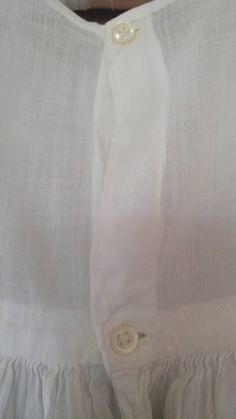 "50s gorgeous white cotton long under dress for a Christening / Baptism. Sleeveless top with two tiny little pearly buttons at the back. Waistband with the long skirt flaring out from it. Bottom of skirt has little tiers of fabric and then a lovely cotton lace trim at the hem. across chest 19\" around, waist 19\" around, skirt length 30\", dress length total 37\"" Solid Color Summer Baptism Dress, Fitted Baptism Dress With Short Sleeves For Summer, White Fitted Cotton Baptism Dress, Fitted White Cotton Baptism Dress, Classic Summer First Communion Dress, Elegant Fitted Baptism Dress For Summer, Elegant Short Sleeve Baptism Dress For Summer, Elegant White Baptism Dress For Daywear, Classic Cotton Baptism Dress For Spring