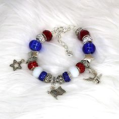 Fabulously patriotic bracelet feature Red White and Blue Beads, an America Charm, a USA charm and a Star charm. Nothing says I love America with more style! ❤️COLORS: Silver Bracelet with Tibetan Silver and Blue Red and White beads.  Three silver charms.  ❤️SIZE: The bracelet comes with a 1 1/2 inch extension chain  to comfortably fit size 6 1/2 to 8.                    ❤️MATERIALS: This bracelet is made of silver plated copper, the beads are Tibetan Silver, blue red and white glass  beads and sparkling crystal beads. All materials are nickel and lead free.  ❤️PROCESSING TIME: Your bracelet will ship within 1 business day after purchase.  ❤️SHIPPING TIME: 2-5 days within the US via USPS First Class Mail. Free shipping on all orders $35 and more in this shop. ❤️GIFTS: You can ship your gift Red Round Beads Bracelets For 4th Of July, Patriotic Red Beaded Bracelets With Round Beads, Patriotic Red Beaded Bracelet With Round Beads, Patriotic Red Beaded Bracelets For Independence Day, Red Beaded Bracelets For Independence Day, Patriotic Red Beaded Bracelet, Independence Day Red Beaded Bracelets With Round Beads, Independence Day Red Beaded Bracelets, Patriotic Red Beaded Bracelets As Gift