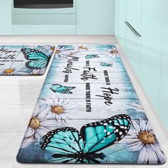 two kitchen mats with blue butterflies and white daisies on the floor in front of an oven