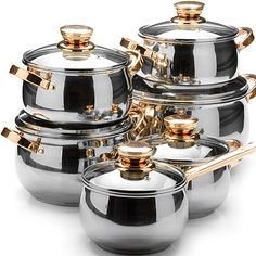 a set of pots and pans with gold handles