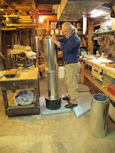 a man is working on a metal object in a workshop with other tools and materials