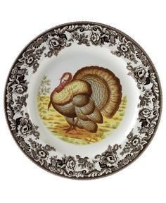 a plate with a turkey painted on it's side and an ornate border around the edge