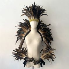 a white mannequin with feathers on it's head