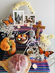 the table is decorated with flowers, candles, and other things to decorate for halloween