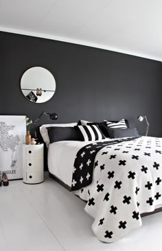 a bedroom with black and white decor in it