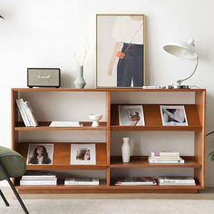 a book shelf with books and pictures on it