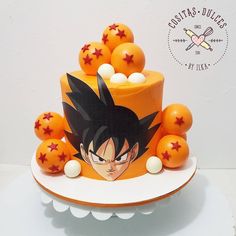 a birthday cake with an image of gohan surrounded by orange balls and stars on top