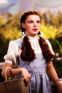 an image of a woman with long hair holding a basket and looking at the camera