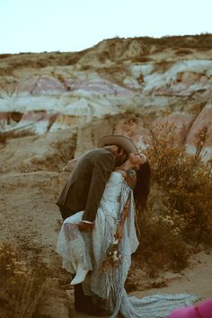 a man and woman kissing in the desert