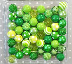 green and yellow ornaments in a clear container