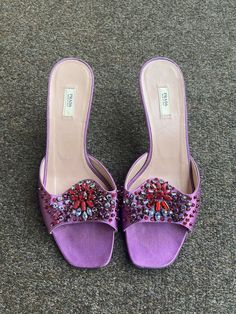 Womens PRADA Beaded Pink Purple Leather Satin Slides Sandals Heel Slipper Sz 36 100% authentic ❌Please check pictures. There were a few beads that came off the shoes.❌ item comes to you in excellent used condition free of rips, stains, tears, strong smells, etc. ❌ Please see all pictures as they are part of the description. The item you see is the EXACT item you are receiving. If you have any questions about any of the images, PLEASE feel free to email. ❌ Please check out my other auctions! Stor Heel Slippers, Slides Sandals, Purple Leather, Sandals Women, Cork Wedge, Pink Purple, Sandals Heels, Womens Sandals, Slides