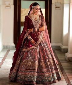 a woman in a red and gold bridal gown