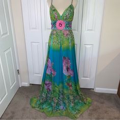 Jovani Sz8 Flowered Lined Deep Neck Full Length Gown Waist Beading With Shrug Absolutely Stunning! Colors Are Vibrant Blues, Greens And Pinks Floral Fully Lined In Blue Waist Has Coordinating Iridescent Beading With Pink Flower At Center Coordinating Twist Rope Straps That Cross In The Back Full Side Zipper With Hook And Eye Latch Chest Stays For Shape And Comfort Worn One Time And Is In Excellent Condition Collar To Hem 62” Matching Shrug Measures 17” Wide And 57” Long, Has Iridescent Small Beading On Trim Clean And Smoke Free Seller Shipping Within 1 Business Day Baddie Dresses, Jovani Dresses, Full Length Gowns, Comfort Wear, Pink Floral, Full Length, Pink Flowers, Prom, Prom Dresses